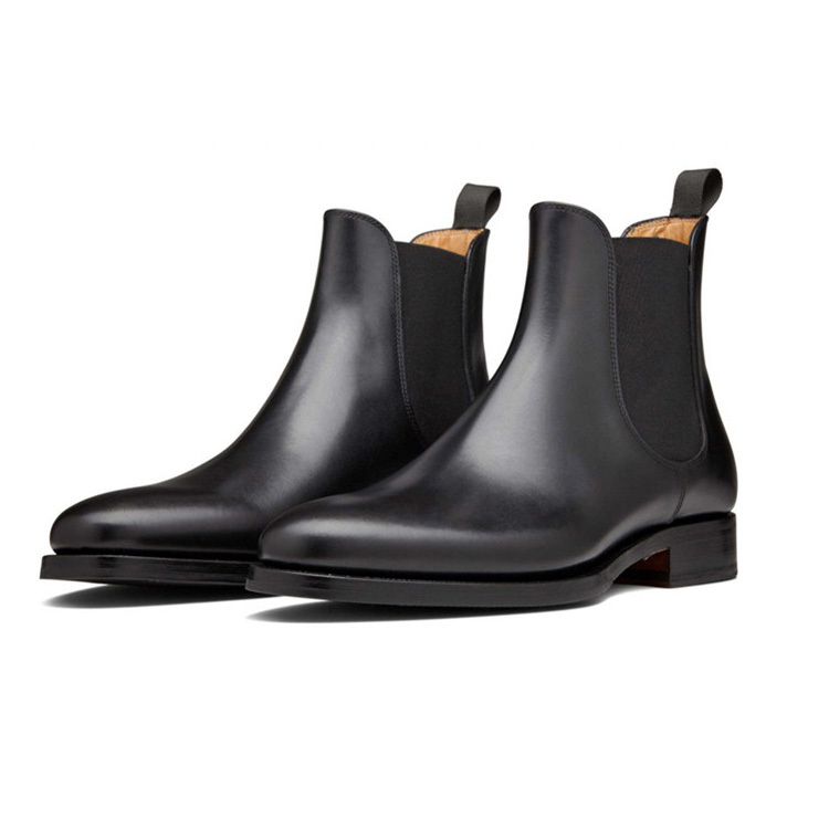 Pair of black leather Chelsea boots with elastic side gores, a rear pull tab and a stacked heel