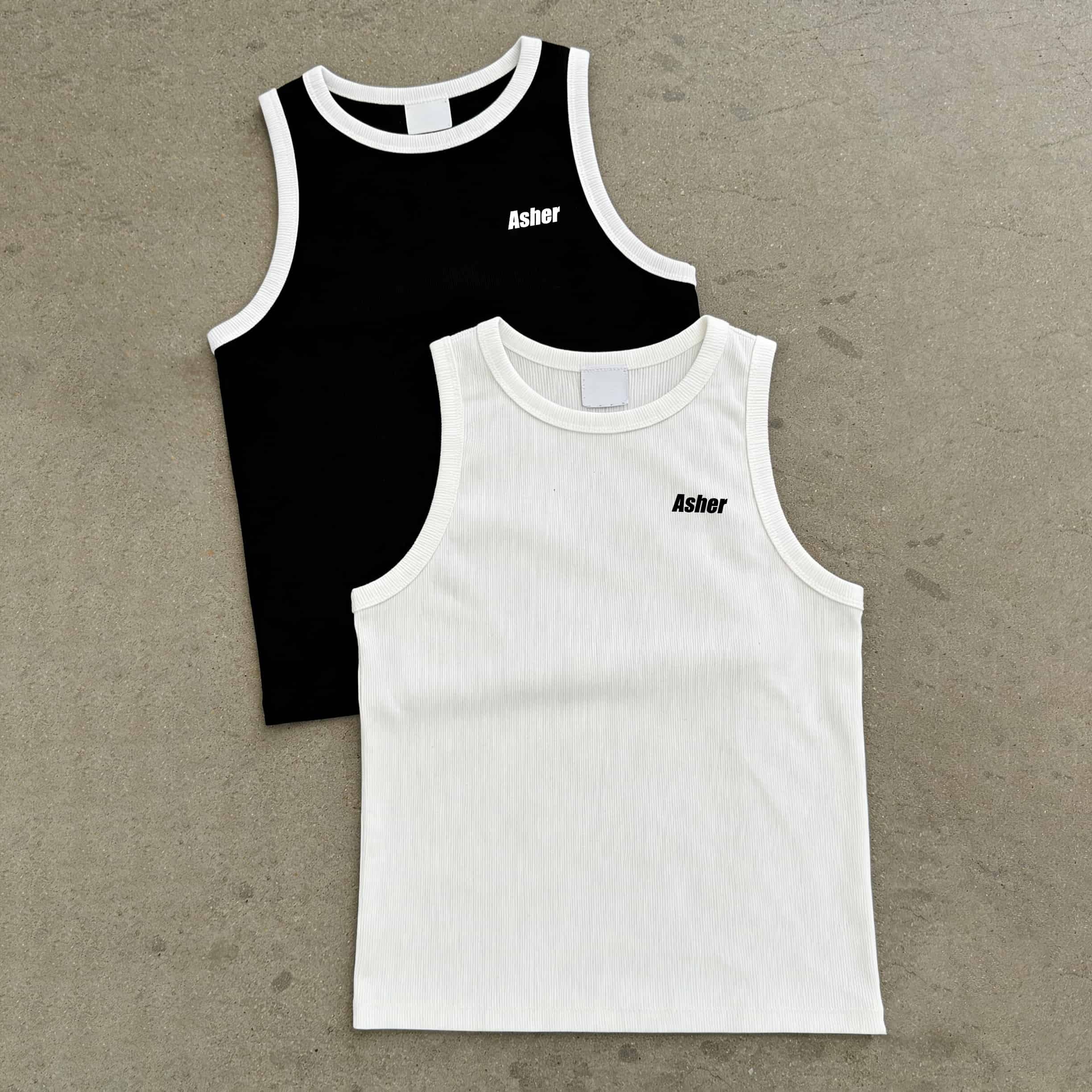 One black and one ivory ribbed cotton tank top with contrast binding at the neckline and armholes