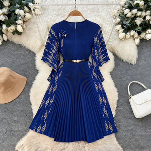 Royal blue pleated midi dress with gold floral embroidery, a V-neck and a slim matching belt